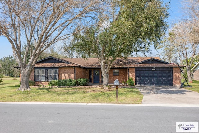 1001 Tesoro Ave, Rancho Viejo, TX 78575 - ranch-style home with a garage, brick siding, concrete driveway, and a front yard