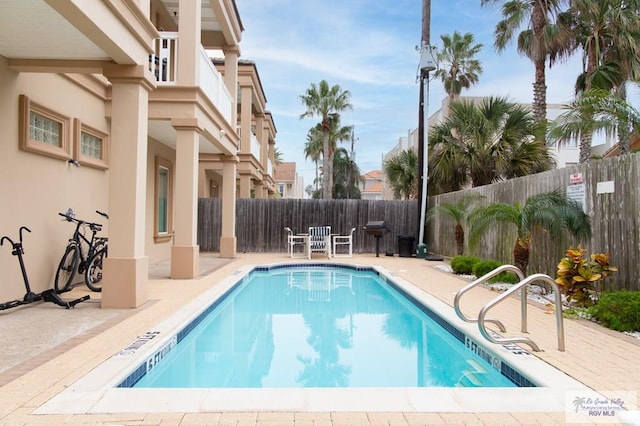 view of swimming pool featuring a patio area