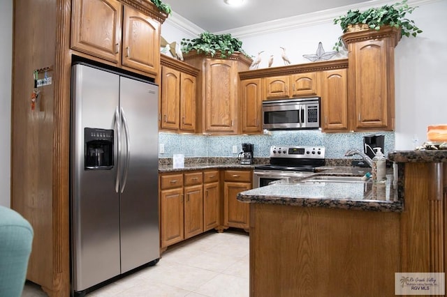 kitchen featuring stainless steel appliances, ornamental molding, sink, and dark stone counters