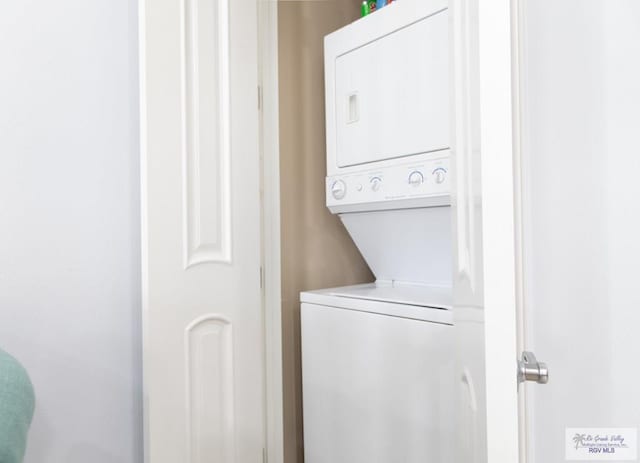 washroom with stacked washer and clothes dryer