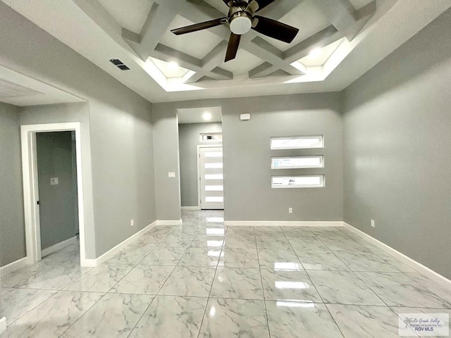 unfurnished room featuring coffered ceiling, a ceiling fan, baseboards, light marble finish floors, and beamed ceiling