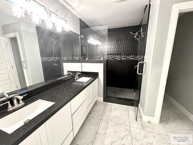 bathroom featuring marble finish flooring, a shower stall, baseboards, and double vanity