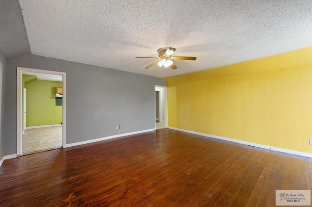 spare room with dark hardwood / wood-style flooring and a textured ceiling