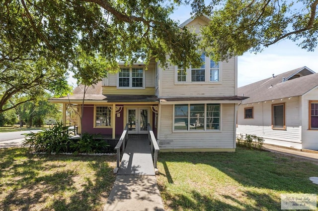 view of front of home featuring a front yard and french doors