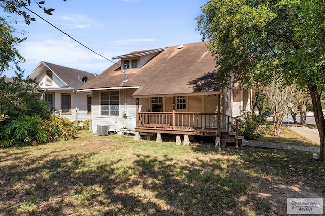 back of house with a lawn, central AC unit, and a deck