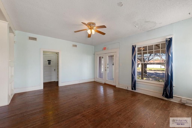 unfurnished room featuring a textured ceiling, dark hardwood / wood-style floors, and ceiling fan