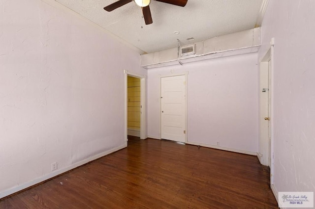 unfurnished bedroom with a textured ceiling, ceiling fan, and dark hardwood / wood-style floors