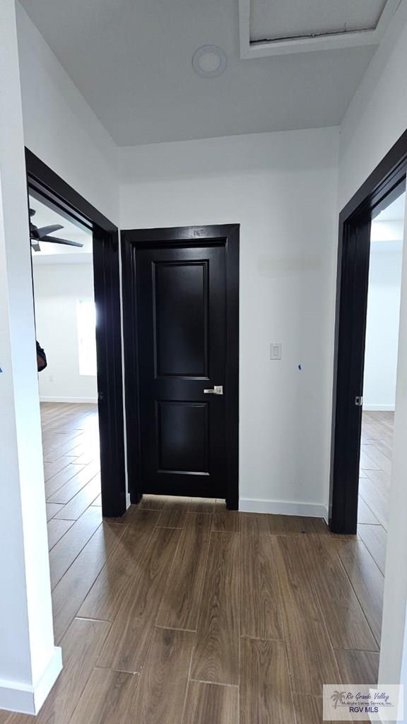 corridor featuring hardwood / wood-style floors