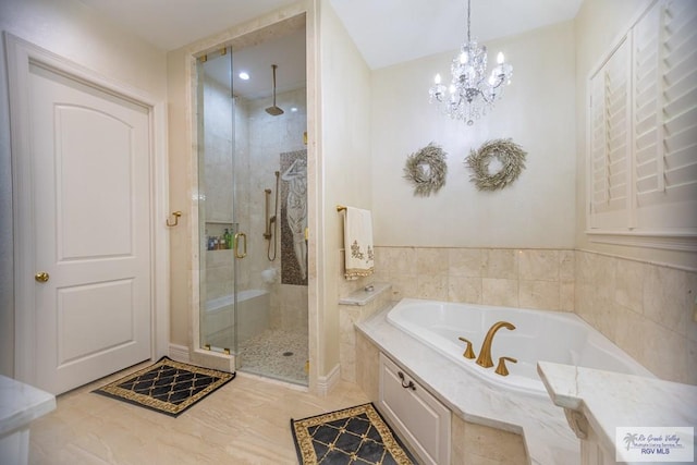 bathroom featuring separate shower and tub, tile patterned floors, and a chandelier