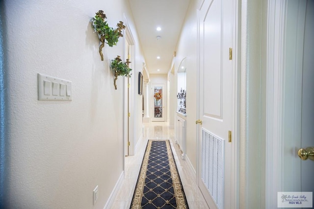 hall featuring tile patterned flooring