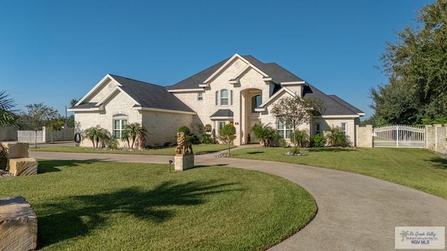 french country inspired facade featuring a front yard