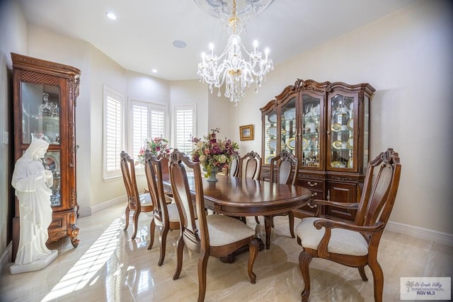 dining space with a chandelier and light hardwood / wood-style flooring