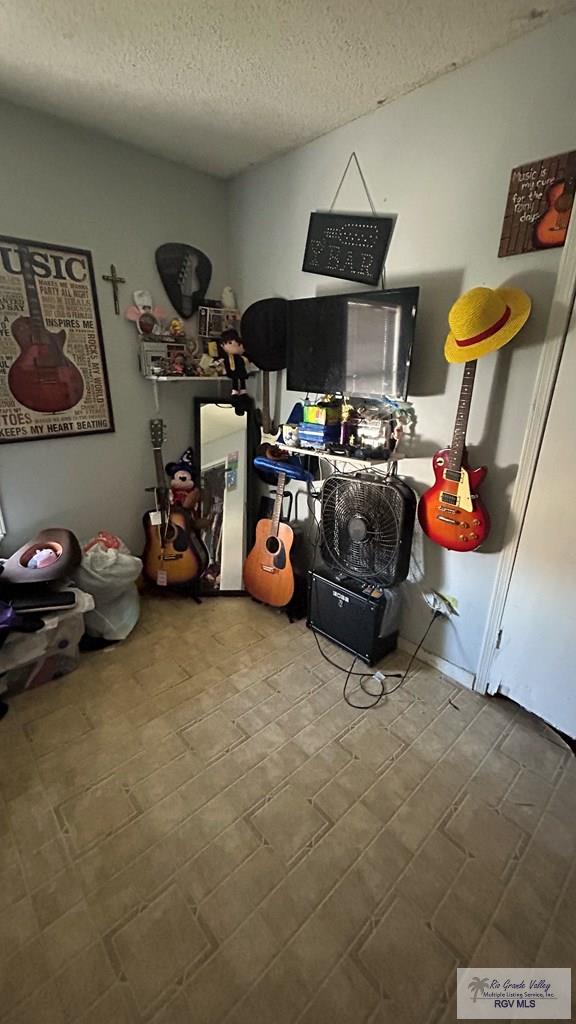 miscellaneous room featuring a textured ceiling