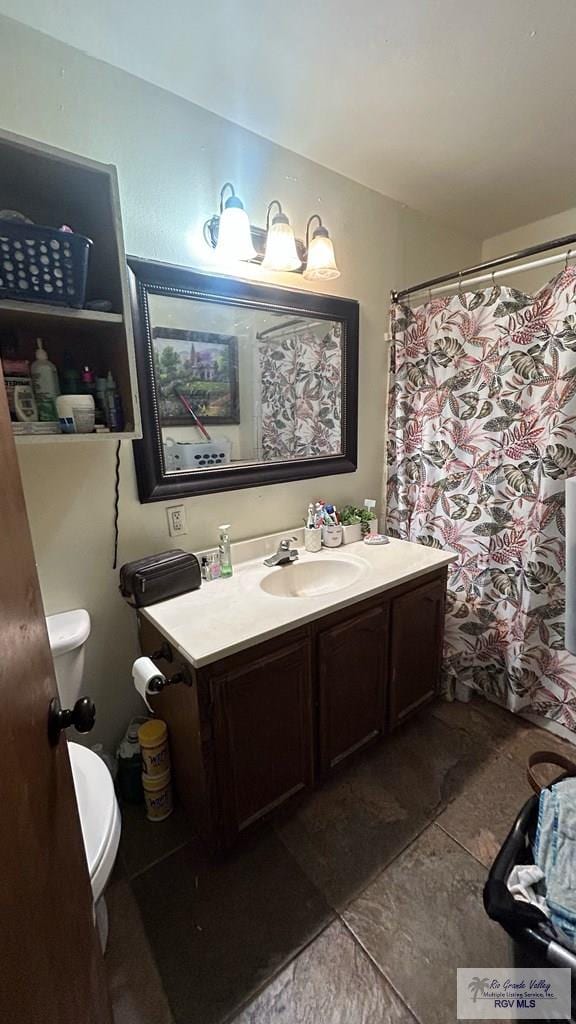 bathroom featuring tile patterned floors, vanity, and toilet