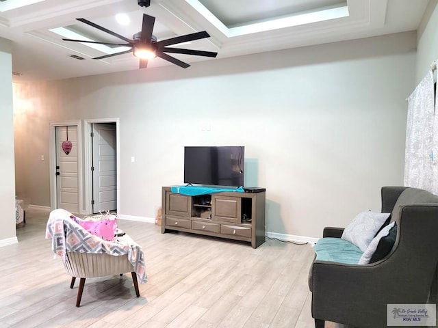 living room with ceiling fan and light hardwood / wood-style floors