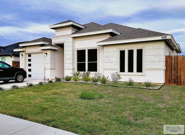 view of front facade featuring a garage and a front lawn