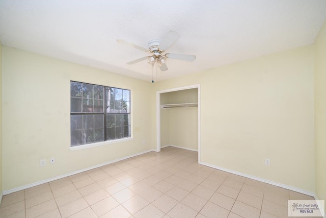 unfurnished bedroom with light tile patterned floors, a closet, and ceiling fan