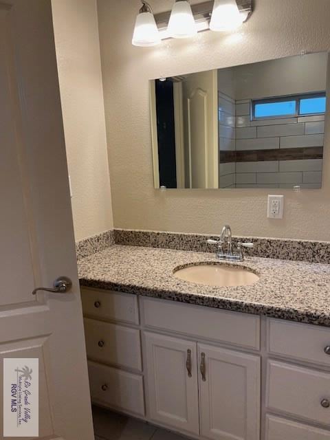 1972 Baja Dr Unit 4, Los Fresnos, TX 78566 - bathroom with vanity and a textured wall