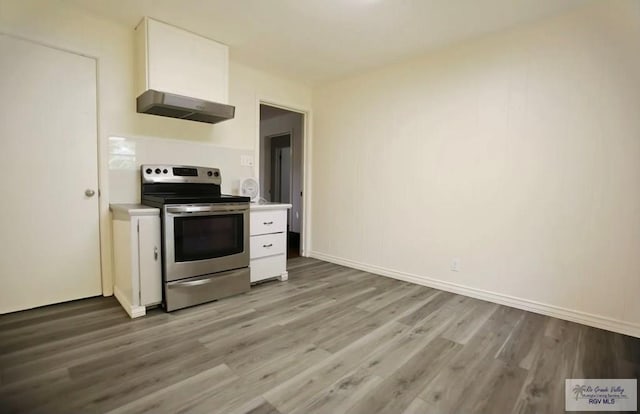 kitchen with stainless steel range with electric stovetop, light wood-type flooring, ventilation hood, and white cabinets