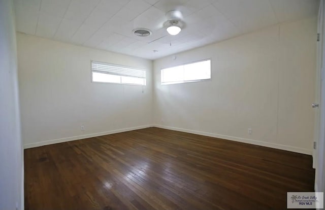 empty room with dark hardwood / wood-style flooring