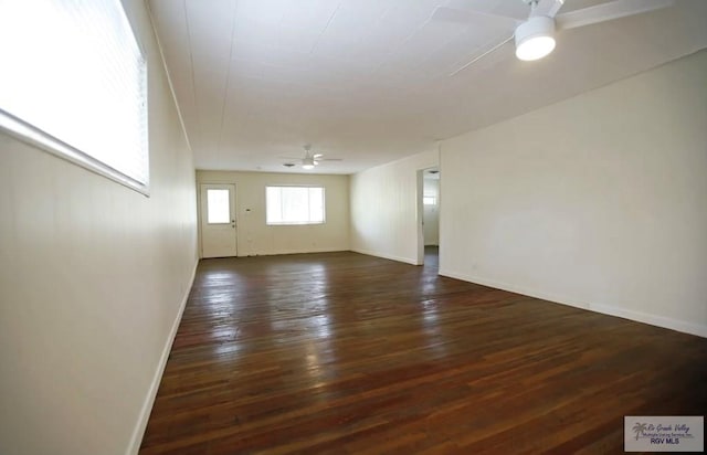 spare room with ceiling fan and dark hardwood / wood-style flooring