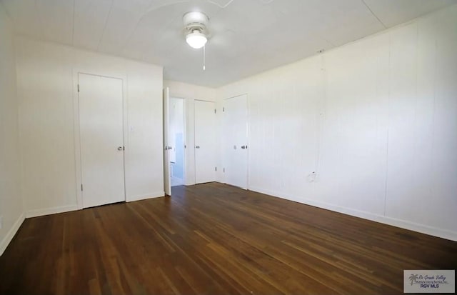 unfurnished bedroom with ceiling fan and dark hardwood / wood-style flooring