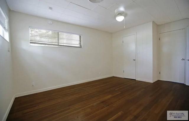 empty room featuring dark wood-type flooring