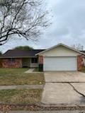 single story home with a garage and a front yard