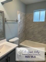 bathroom featuring vanity and tiled shower