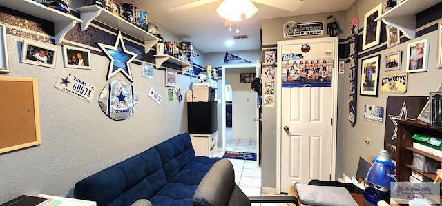 interior space with a ceiling fan, tile patterned flooring, and visible vents