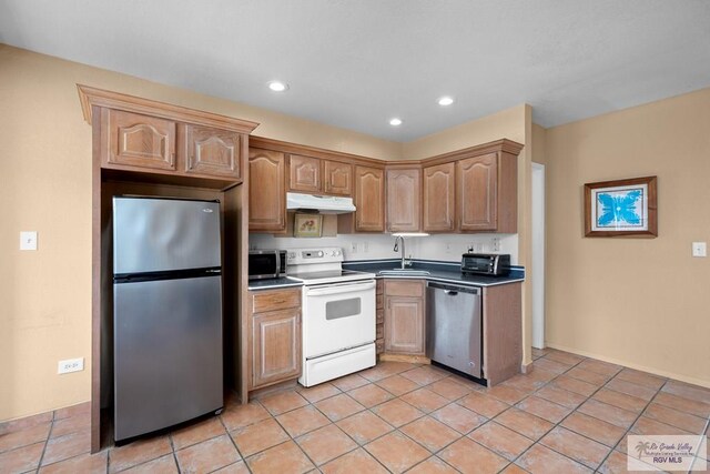 131 Windward Dr, Port Isabel, TX 78578 - kitchen with under cabinet range hood, recessed lighting, stainless steel appliances, and a sink