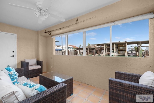 131 Windward Dr, Port Isabel, TX 78578 - tiled living area featuring a textured wall and a ceiling fan