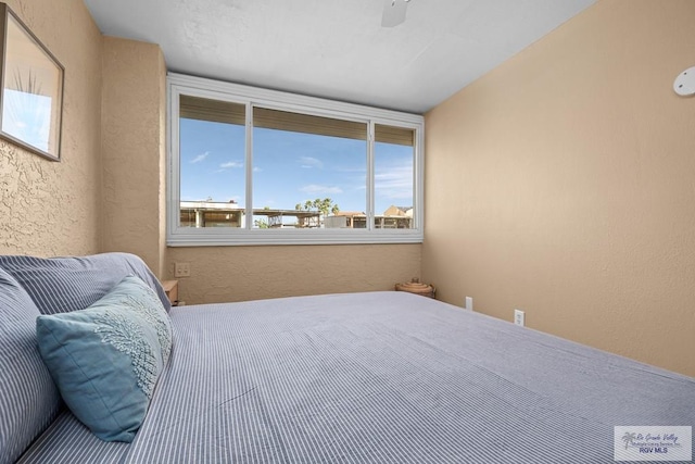 131 Windward Dr, Port Isabel, TX 78578 - bedroom with ceiling fan and a textured wall