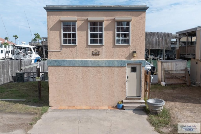 131 Windward Dr, Port Isabel, TX 78578 - view of front facade with stucco siding, fence, and entry steps