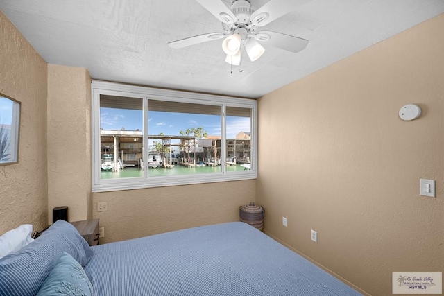 131 Windward Dr, Port Isabel, TX 78578 - bedroom with ceiling fan and a textured wall