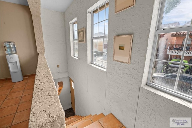 131 Windward Dr, Port Isabel, TX 78578 - staircase with a textured wall and tile patterned floors