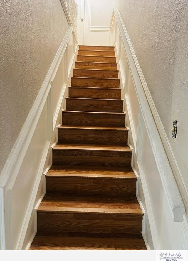 staircase featuring hardwood / wood-style floors