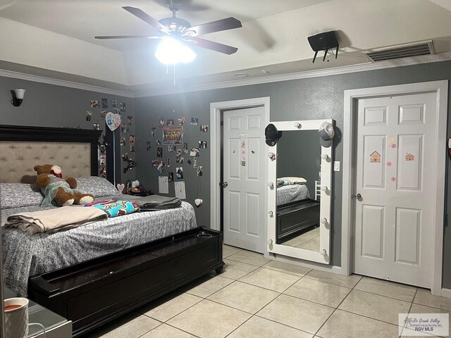 tiled bedroom with ceiling fan and ornamental molding