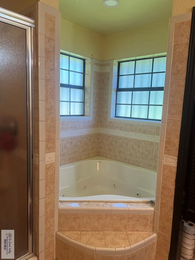 bathroom featuring shower with separate bathtub