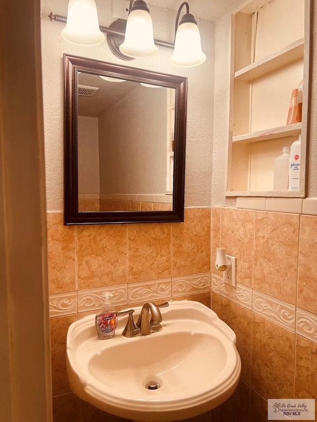 bathroom with tile walls and sink