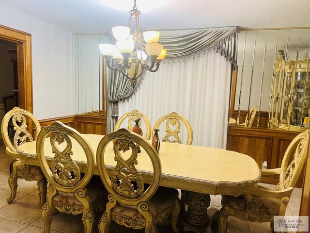 tiled dining area with an inviting chandelier