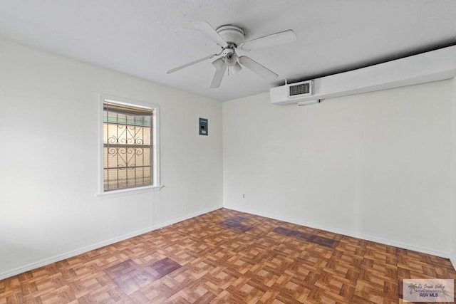 empty room with visible vents, ceiling fan, and baseboards