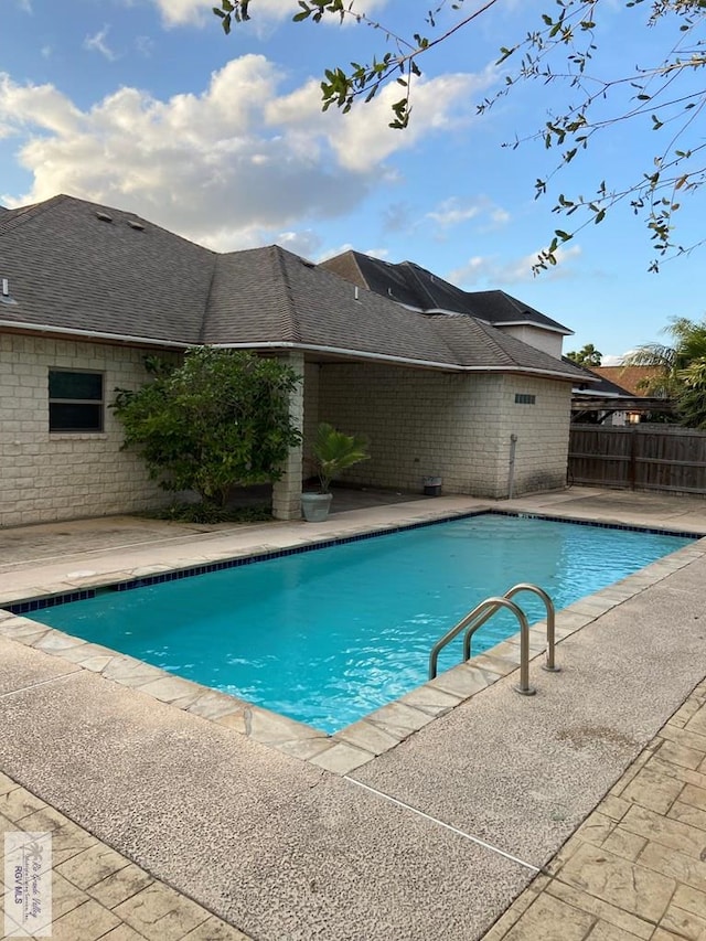 view of swimming pool featuring a patio area