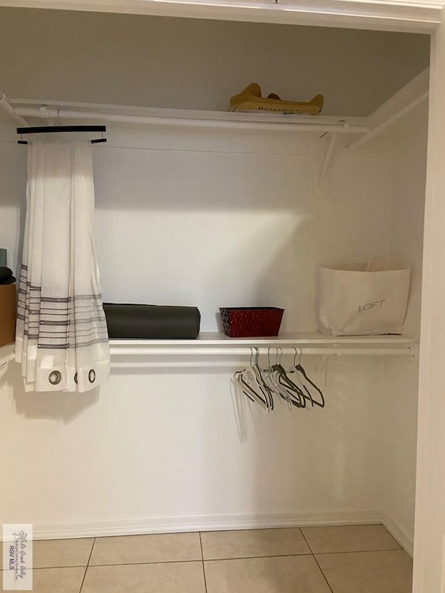 spacious closet with light tile patterned floors