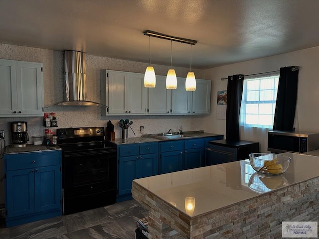 kitchen featuring sink, wall chimney exhaust hood, blue cabinetry, black / electric stove, and decorative light fixtures