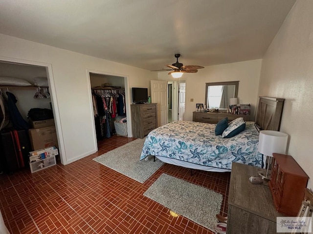 bedroom with ceiling fan and a spacious closet