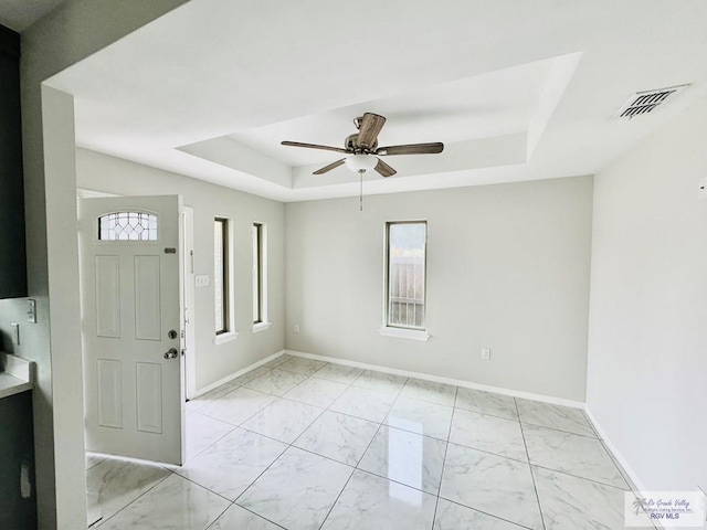 43 El Paso Rd, Brownsville, TX 78520 - foyer with visible vents, baseboards, marble finish floor, a raised ceiling, and a ceiling fan