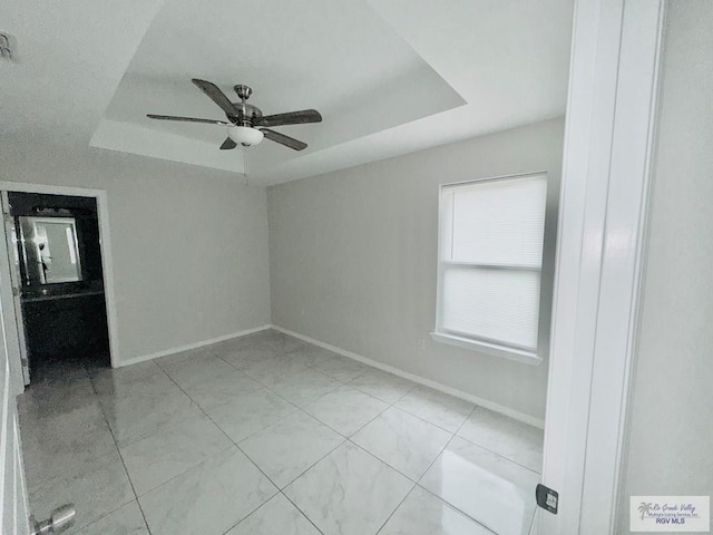 43 El Paso Rd, Brownsville, TX 78520 - unfurnished room with a raised ceiling, baseboards, and ceiling fan