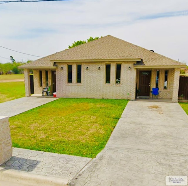 43 El Paso Rd, Brownsville, TX 78520 - single story home featuring brick siding, a front lawn, and a shingled roof