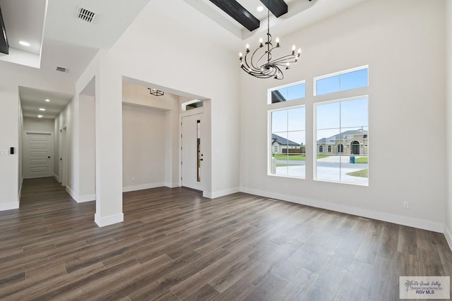 25219 Chelsea Ln, Harlingen, TX 78552 - unfurnished dining area featuring a chandelier, dark wood-style flooring, baseboards, a towering ceiling, and recessed lighting